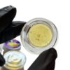 "Fresh pressed rosin for sale in glass concentrate jar showing light gold color and glossy texture"