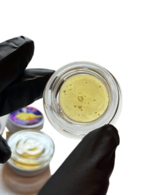 "Fresh pressed rosin for sale in glass concentrate jar showing light gold color and glossy texture"