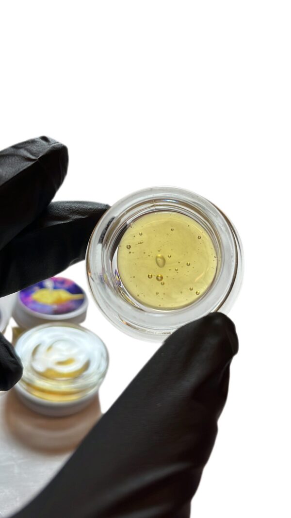 "Fresh pressed rosin for sale in glass concentrate jar showing light gold color and glossy texture"